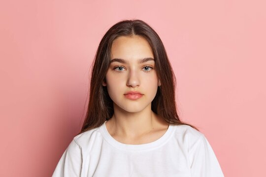 Portrait Beautiful Young Girl White Tshirt Posing Looking Camera Isolated Pink Studio Background