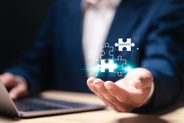 Success concept. Strategic planning towards business success goals. Businessman holding puzzle...