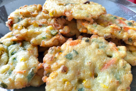 Perkedel Jagung or Bakwan Jagung, corn fritters is Indonesian traditional food. Savoury snack made of corn, egg, flour, spring onion, pepper and salt. Served in plate.
