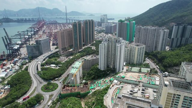 High-rise residential buildings under construction in Tsing Yi near Tsuen Wan Kwai Chung ,a commercial seaside satellite new town, built on a bay in New Territories of Hong Kong, Aerial drone City sky