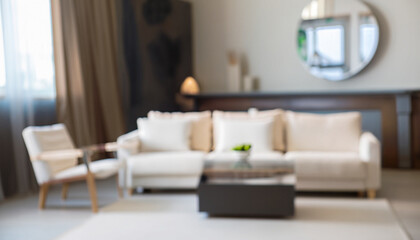 Blurred view of living room interior with white sofa, armchair and coffee table; selective soft-focus; abstract creative background