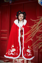 An Asian girl outdoors wearing ancient clothing during the Chinese Spring Festival