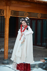 Fototapeta na wymiar An Asian girl outdoors wearing ancient clothing during the Chinese Spring Festival