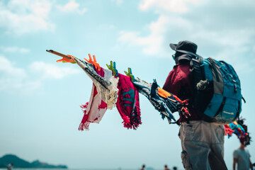 Beach towels and people selling them - obrazy, fototapety, plakaty