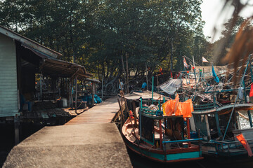 Fototapeta na wymiar Fisherman's village and fishing boats at the canal by the sea.​Fisherman's village and fishing boats at the canal by the sea.​Fisherman's village and fishing boats at the canal by the sea.​