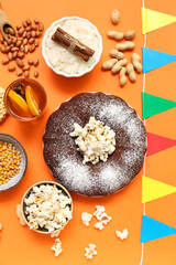 Traditional food with flags for Festa Junina (June Festival) on color background