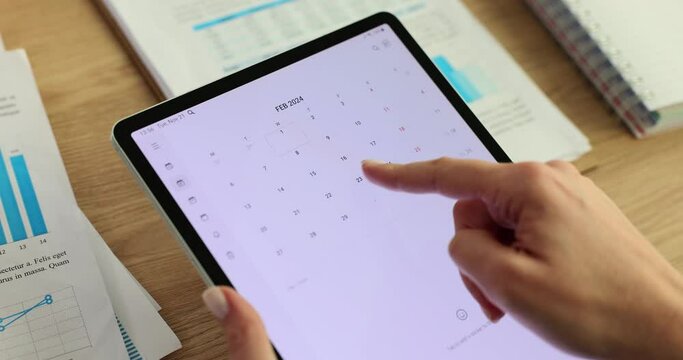 Closeup of businesswoman hands looking at calendar with daily agenda on laptop computer