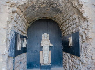 Statue of Artemis within a dark doorway framed by stone walls at the Ephesus archaeological site in...