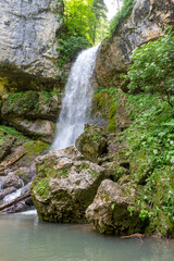 the beginning of summer, mountain river, waterfall, walking along the canyon , hiking trails and recreation in the mountains.