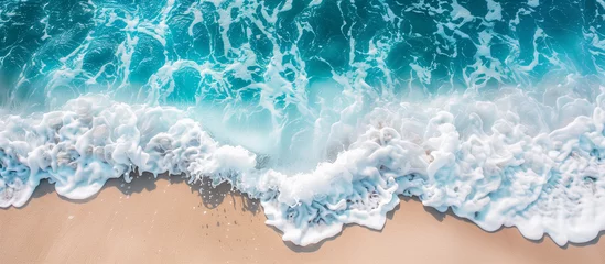 Fotobehang Soft blue ocean wave on fine sandy beach - nature, water, and relaxation © Thumbs