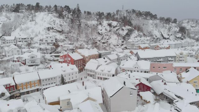 Kragero, Telemark County, Norway - A Delightful Town Adorned with a Blanket of Snow on a Wintry Day - Orbit Drone Shot