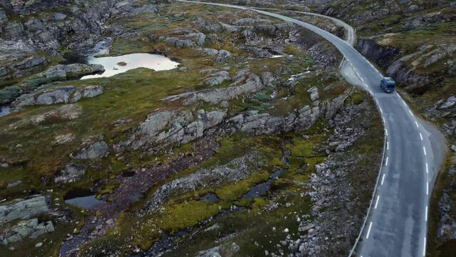 Aerial footage of blue van on small road in Norway. Amazing landscape.