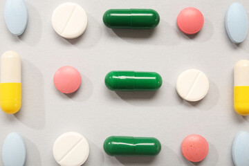 Different pills on grey background