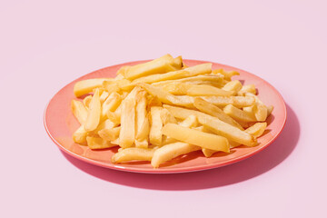 french fries on pink plate, french fries on pink background.