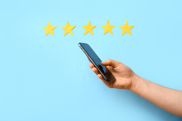 Five stars rating and woman with mobile phone on blue background. Customer experience concept