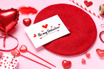 Composition with greeting card, stylish beret and different decor for Valentine's Day celebration on pink background