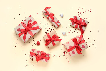 Gift boxes with hearts and confetti on yellow background. Valentine's Day celebration
