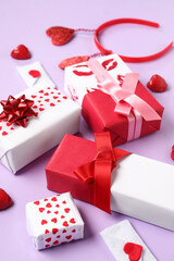 Gift boxes with hearts and festive headband on lilac background. Valentine's Day celebration