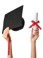 Female hands with graduation hat and diploma on white background