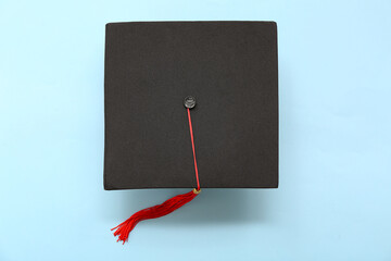 Graduation hat on blue background