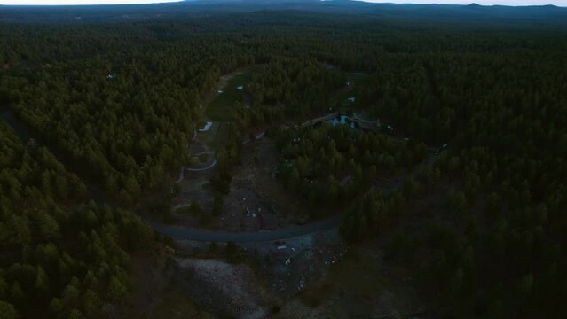 Aerial View of Small Residential Community in Woods of Arizona USA, Houses and Evergreen Forest in Twilight, Drone Shot