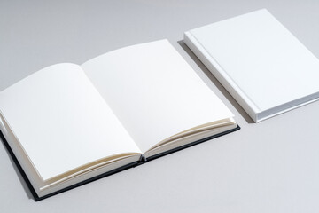 Blank open notepad on gray background studio shot