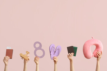Female hands with documents, paper figure 8, flip-flops and travel pillow on color background....