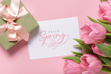 Greeting card with text HELLO SPRING, gift box and beautiful tulips on pink background