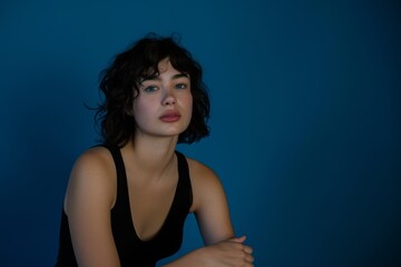 Fototapeta premium woman sitting with blue background