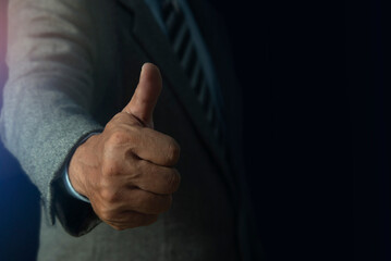 Closeup of thumbs up symbol, Businessman show thumb up gesture. Success person concept