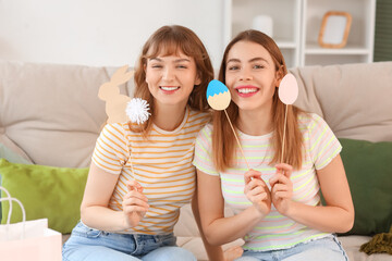 Happy young women with decor for Easter at home