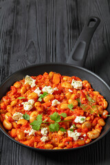 greek giant baked beans with feta on pan