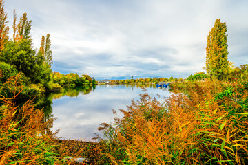 Flückiger Lake near Freiburg im Breisgau with the surrounding nature. Autumn landscape by the...