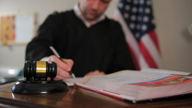 Judge's hand with wooden judge gavel, Focus on judge gavel. Slow motion close up footage