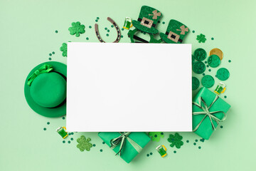 Saint Patrick Day green background with hat, shamrock clover and accessories with gifts top view....