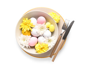 Beautiful table setting with Easter eggs and chrysanthemum flowers on white background