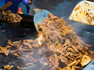 Sizzling Delight: A Close-Up of Grilled Meat and Onions