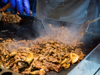 Sizzling Delight: A Close-Up of Grilled Meat and Onions