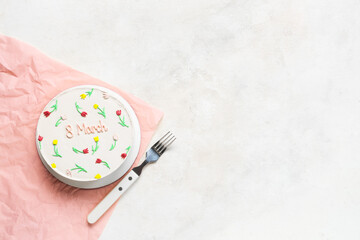 Sweet bento cake and fork on white background. International Women's Day