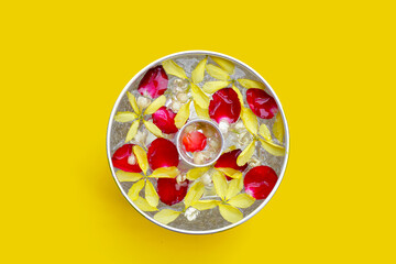 Water with jasmine flower golden shower and rose petals in silver bowl. Thai tradition, Songkran...