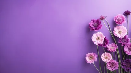Foto op Canvas Beautiful delicate purple flowers on a purple background. Abstract layout of a colored frame with space for text. An invitation to a wedding. The concept of International Women's Day, Mother's Day. © Cherkasova Alie