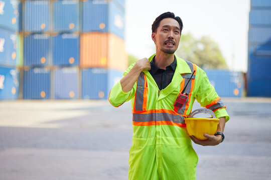 technician or worker feeling tired from work in containers warehouse storage