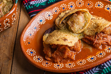 Gorditas de chicharron in green sauce and red sauce. Mexican food.