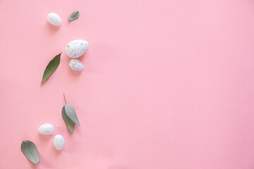 Creative Easter composition made of white eggs and eucalypt on pink background. Copyspace