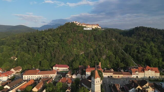 Rasnov Town and Fortress Castle on top of a hill in Carpathians, Romania - Aerial 4k Pedestal