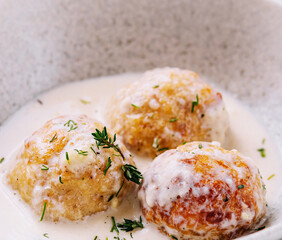 Creamy sauce fried meatballs on plate