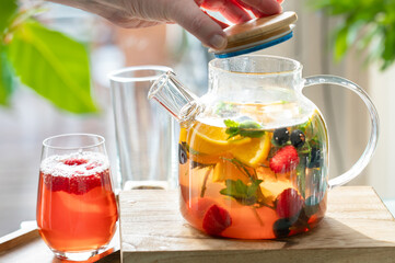Fruit red tea with berries in glass tea cup