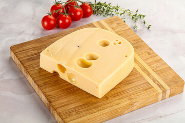 Maasdam cheese brick over board