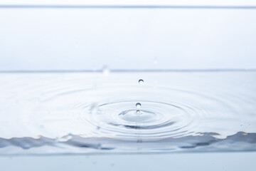 Captivating splash created by a pristine water droplet reflecting its surroundings. Perfect for...
