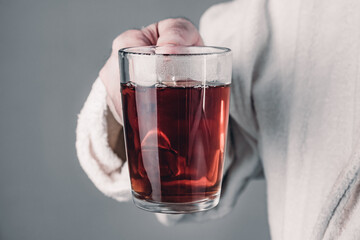 An adult man holds the cup. Man spends time at home, relaxing, and feeling carefree, enjoying morning tea.